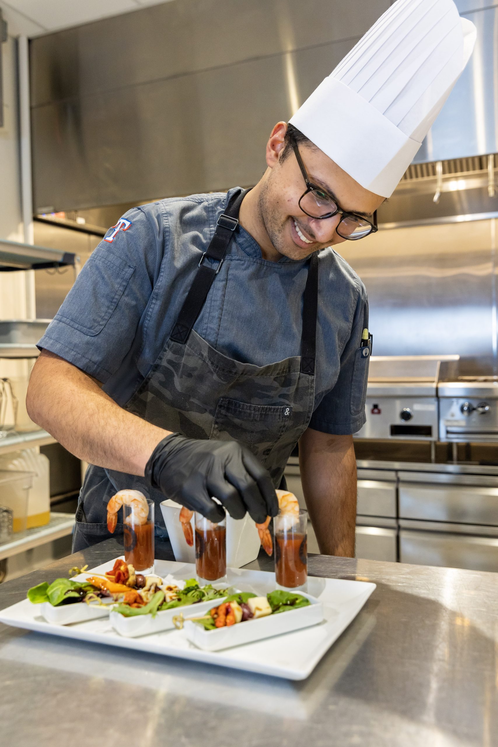 Chef adding shrimp to dish