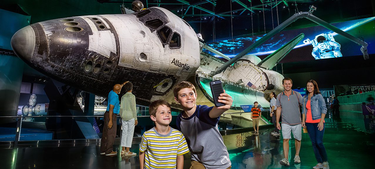 2013_A family taking a selfie in front of the NASA Space Shuttle Atlantis Exhibit at Kennedy Space Center 2013_A family taking a selfie in front of the NASA Space Shuttle Atlantis Exhibit at Kennedy Space Center