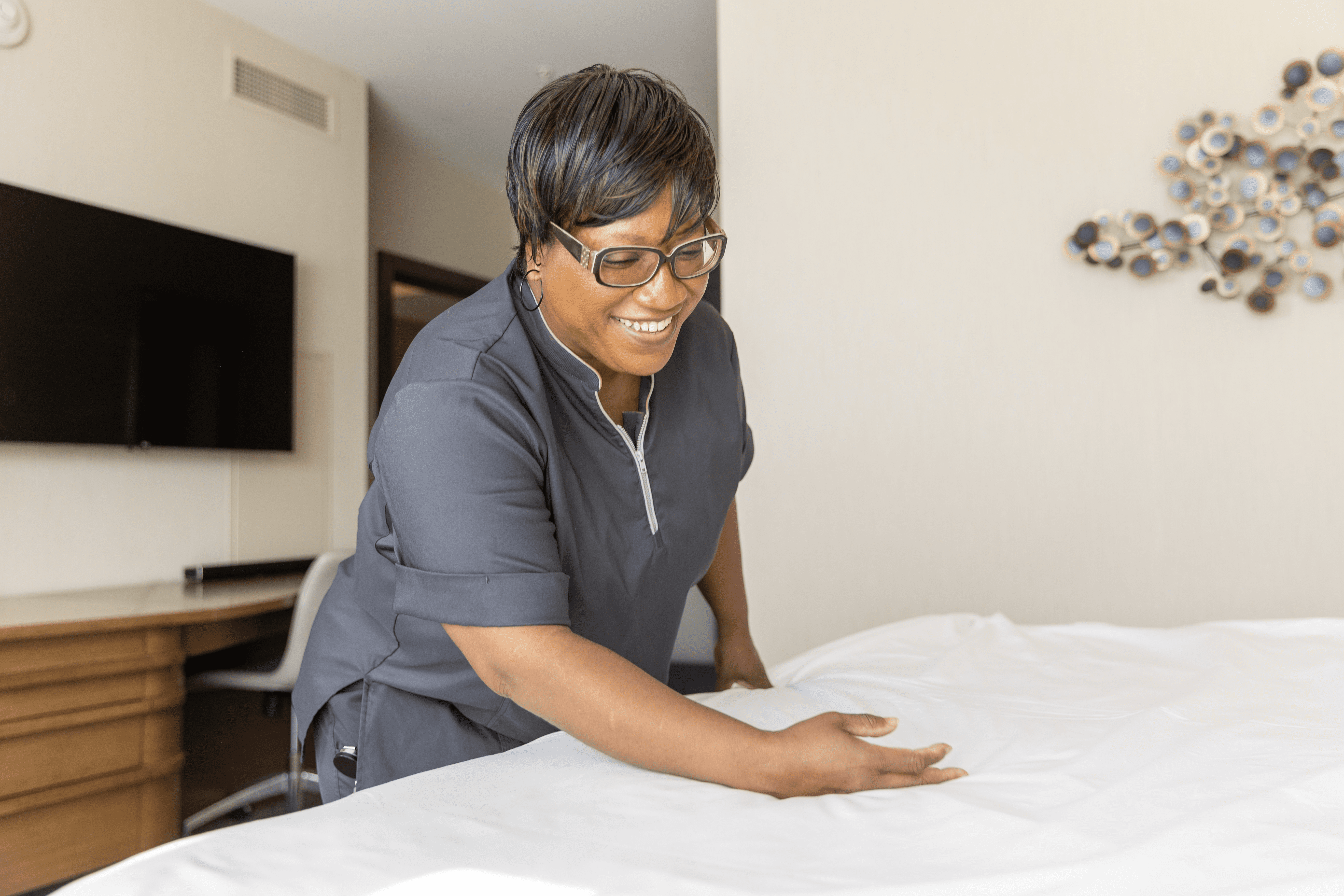 Housekeeper making a bed