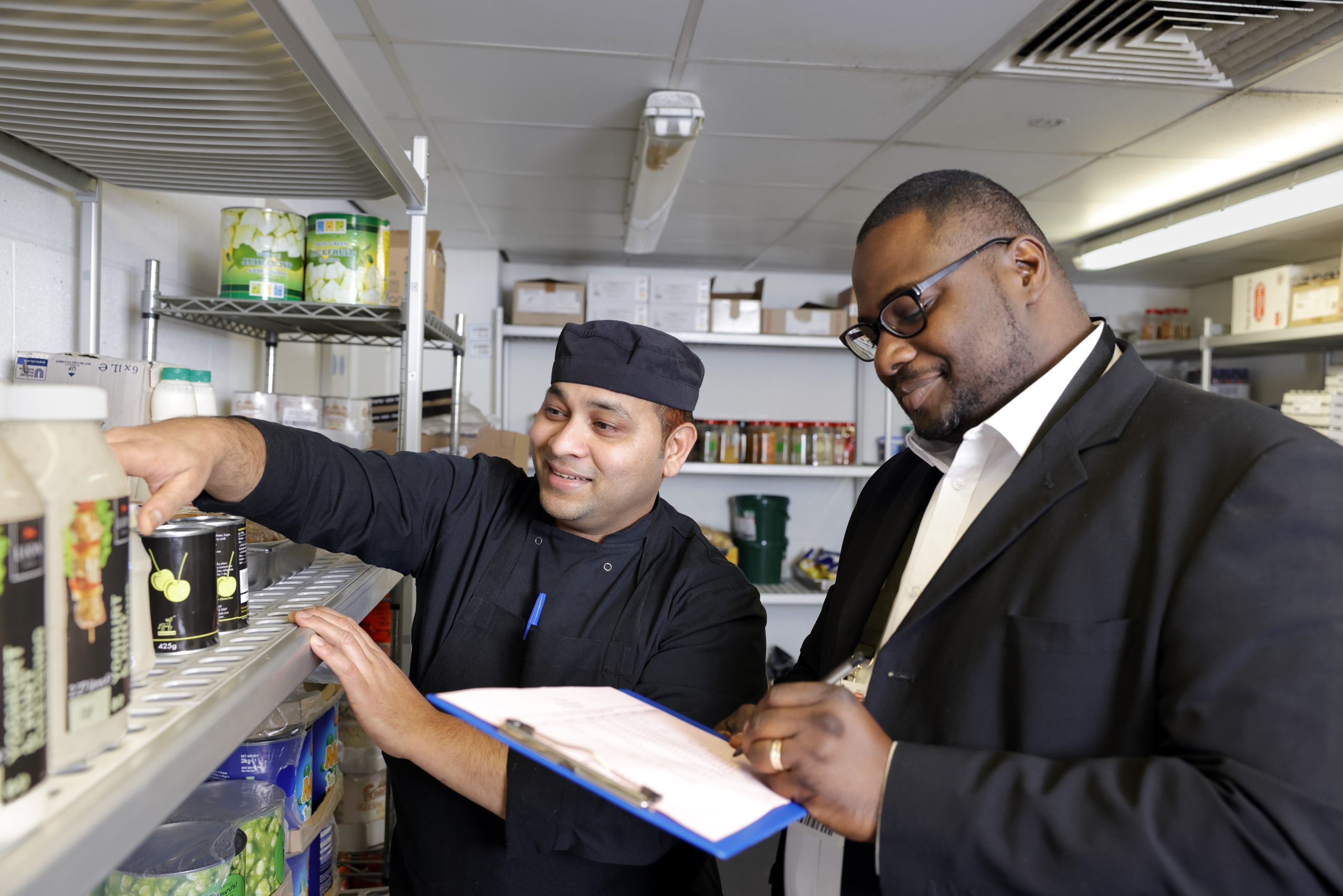Chef and logistics team member doing stock take