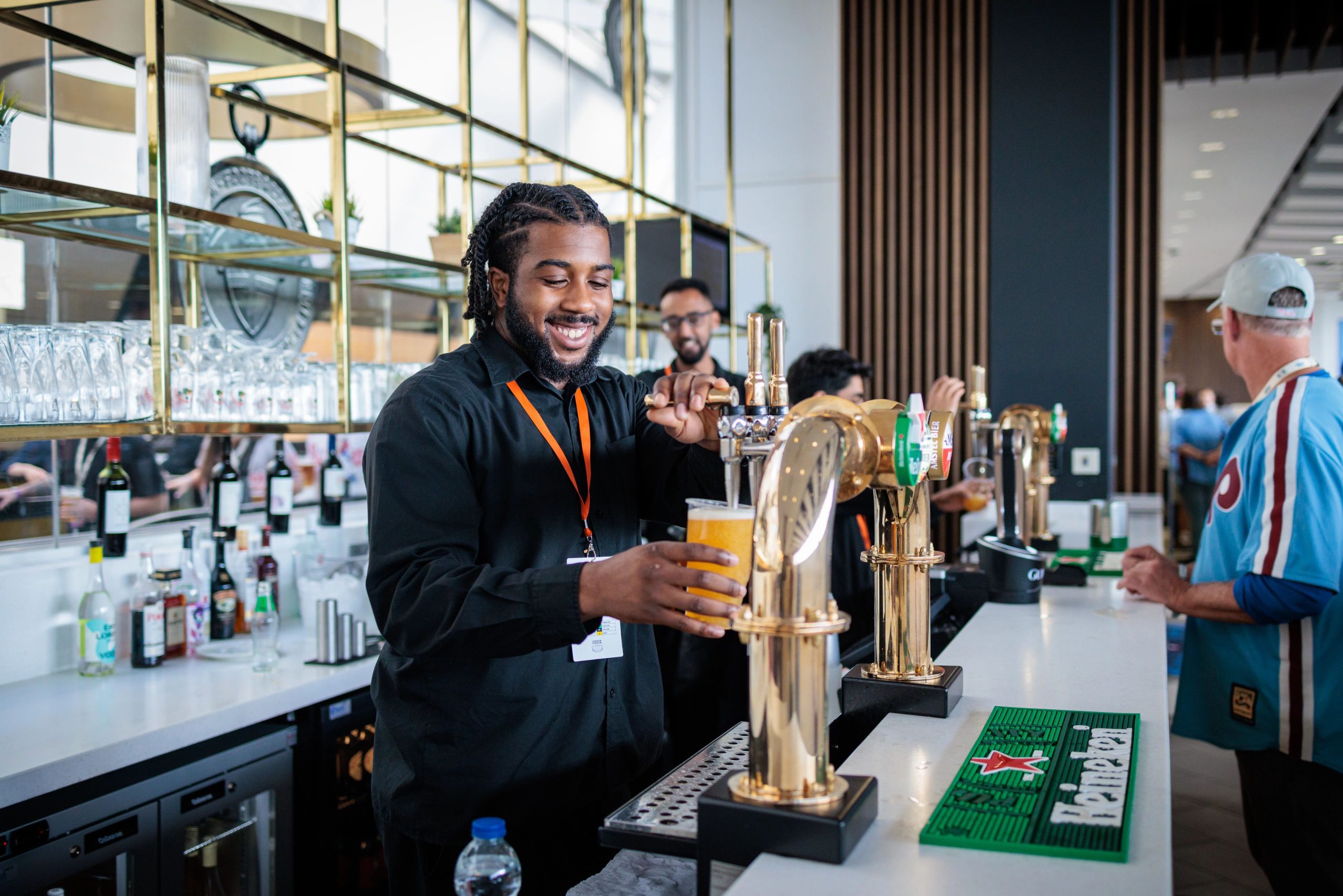 Bartender pouring a pint and smiling