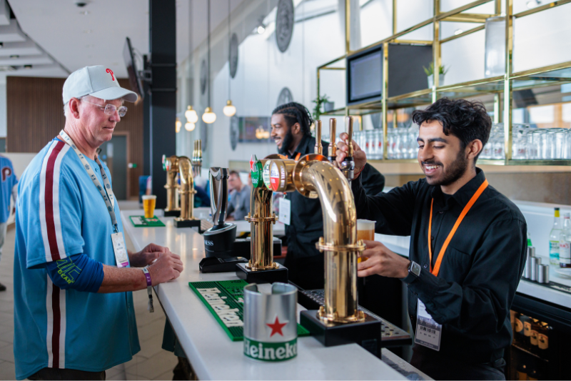Bartender smiling while pouring pint for guest