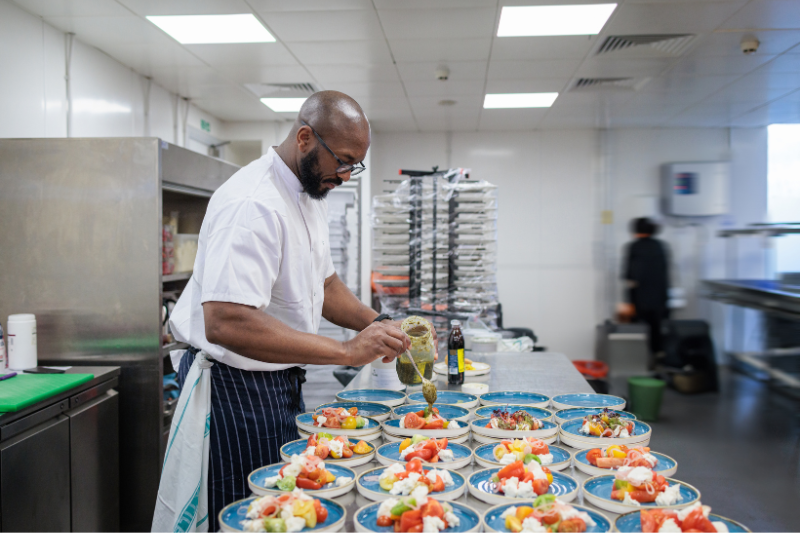 Chef plating up salad starters