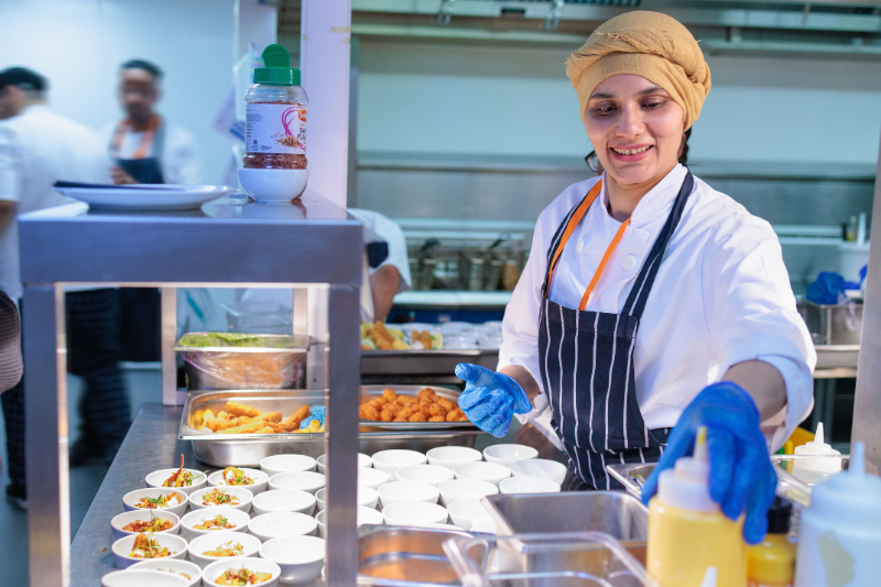 Prep Chef smiling while plating dishes