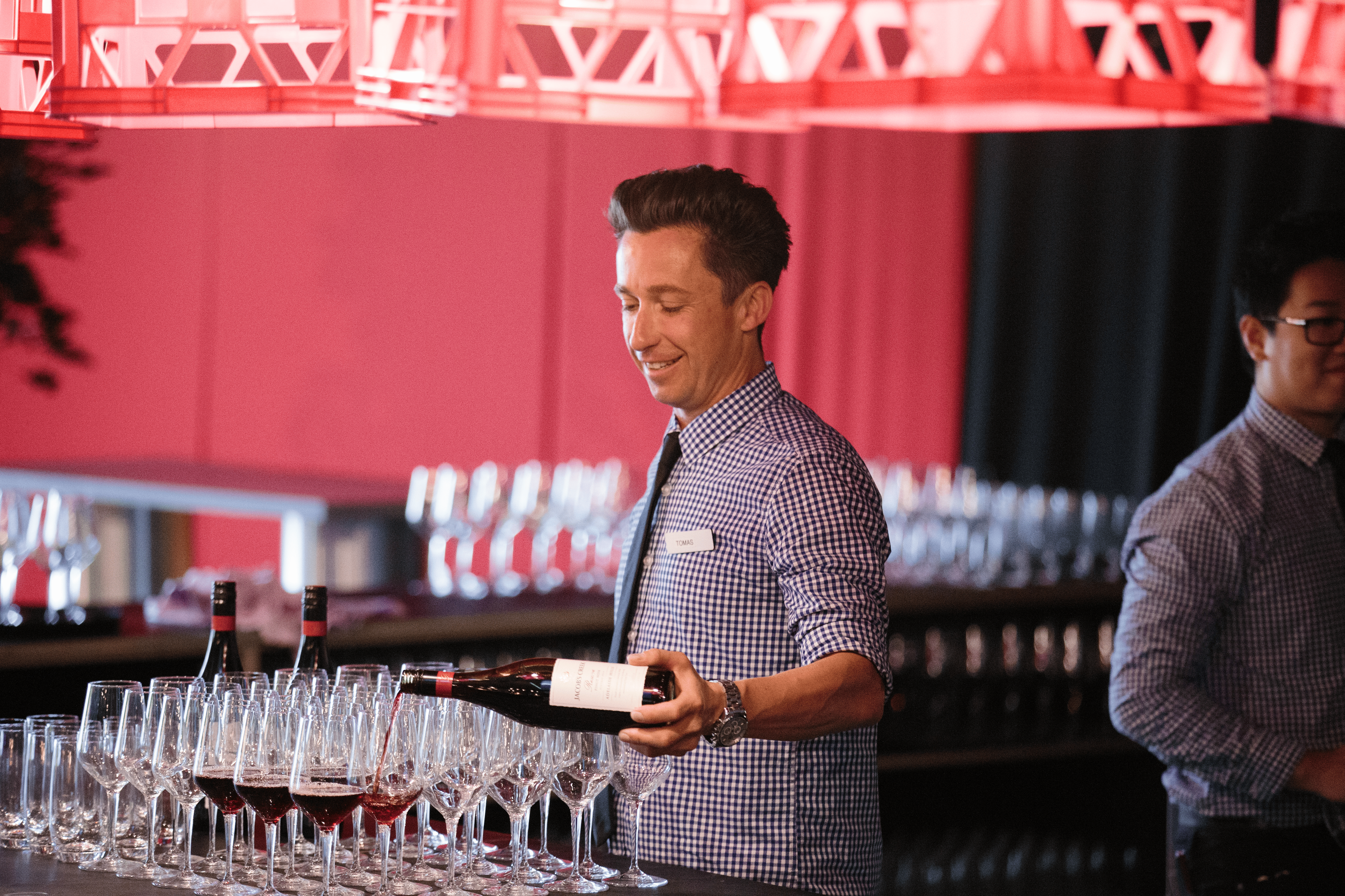 Bartender pouring wine at an event