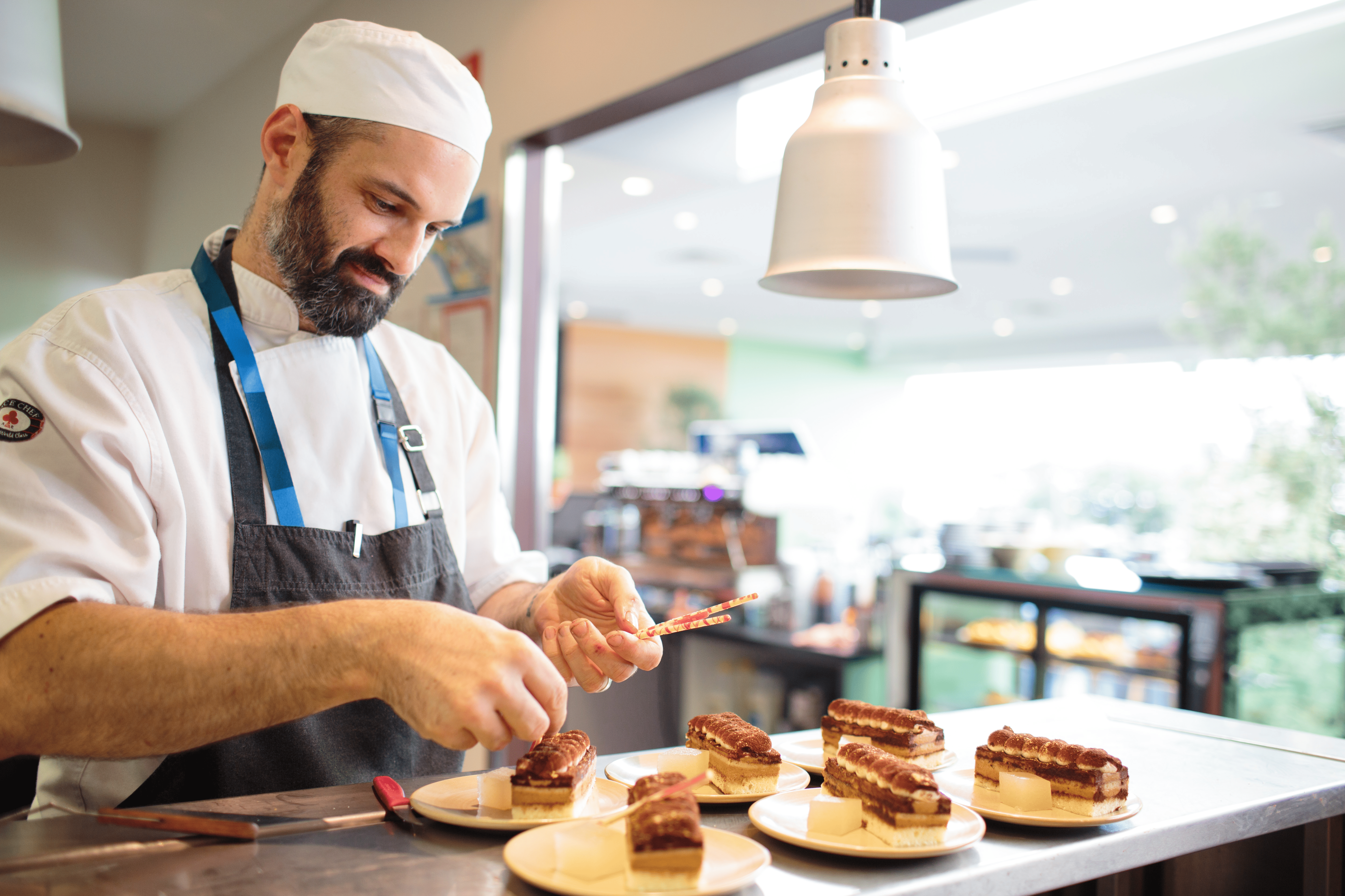 Executive chef prepping plates front of house
