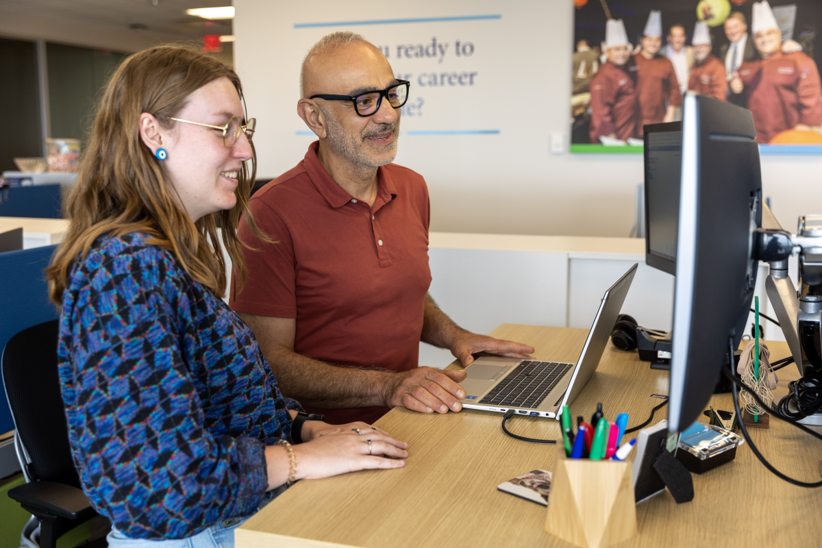 Two team members working at computer