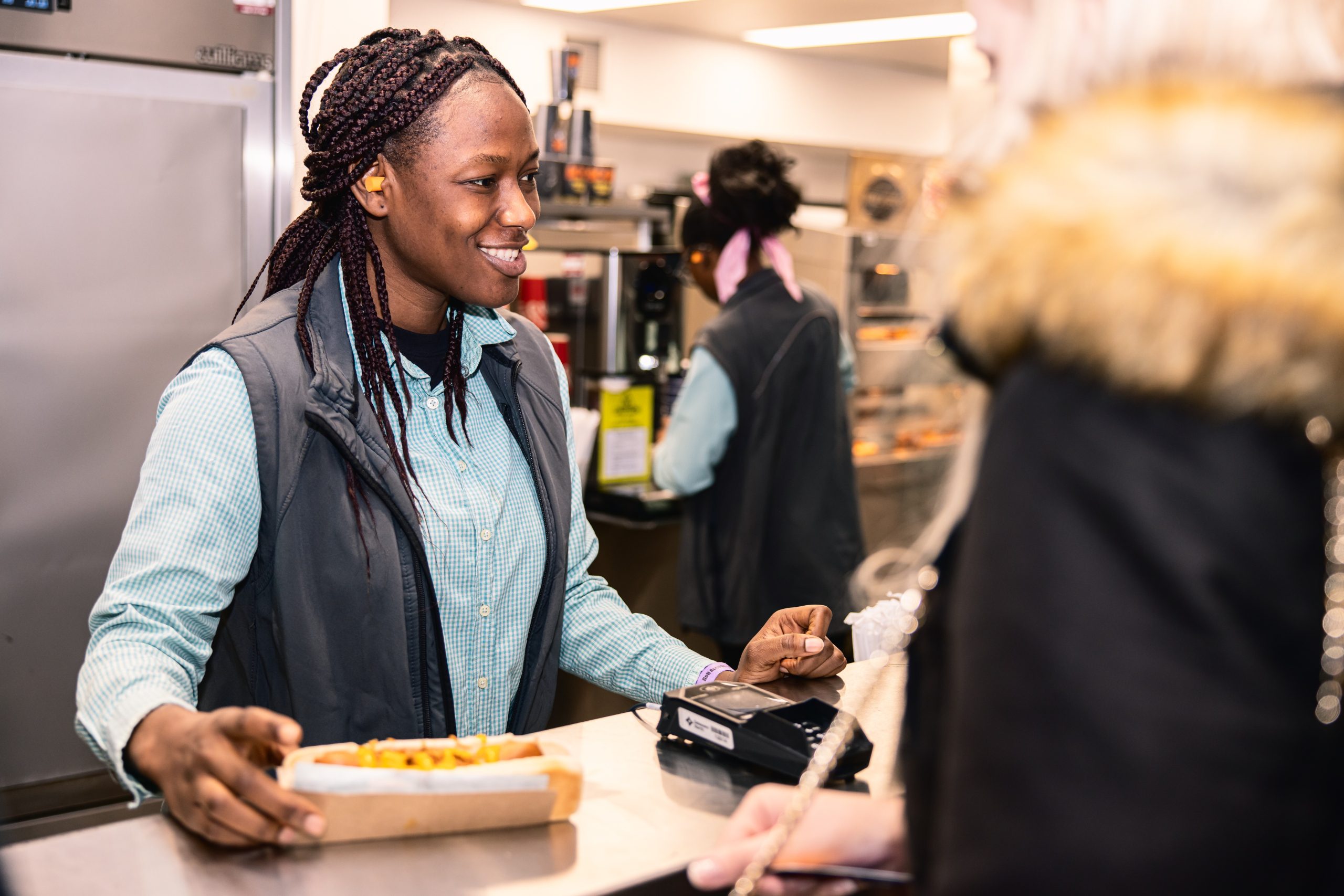 Concessions team member handing food to guest